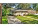 Charming bungalow with screened porch and well-manicured lawn at 1127 N Stella Ave, Lakeland, FL 33805