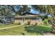 House exterior showcasing a screened porch and landscaped yard at 1127 N Stella Ave, Lakeland, FL 33805