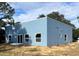 Blue house showcasing rear elevation with modern design and large windows at 2626 Magnolia Cir, Lake Wales, FL 33898