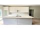 Modern kitchen featuring white cabinets, quartz countertops, and a large island at 2626 Magnolia Cir, Lake Wales, FL 33898