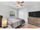 Bedroom with a queen bed, ceiling fan, and dresser at 2233 20Th Nw St, Winter Haven, FL 33881