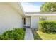 Inviting front entrance with walkway, landscaping, and a freshly painted white brick exterior at 2233 20Th Nw St, Winter Haven, FL 33881