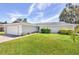 Single story home with attached garage and manicured lawn at 2233 20Th Nw St, Winter Haven, FL 33881