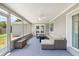 Relaxing screened porch with wicker furniture and ceiling fan at 2233 20Th Nw St, Winter Haven, FL 33881