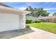 View of the home's exterior, showcasing attached garage and walkway at 2233 20Th Nw St, Winter Haven, FL 33881