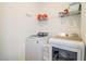 Laundry room with washer, dryer, and shelving at 731 Griffon Ave, Lake Alfred, FL 33850