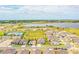 Aerial view of a new home community with a lake and amenities at 731 Griffon Ave, Lake Alfred, FL 33850