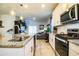 Modern kitchen with white cabinets, granite countertops and stainless steel appliances at 731 Griffon Ave, Lake Alfred, FL 33850