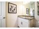 Bathroom with granite countertop, white cabinets, and a mirror at 731 Griffon Ave, Lake Alfred, FL 33850