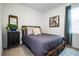 Bedroom with a queen bed, dark wood frame, and gray bedding at 731 Griffon Ave, Lake Alfred, FL 33850