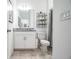 Bathroom with granite countertop, white cabinets and shower at 731 Griffon Ave, Lake Alfred, FL 33850