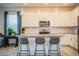 Modern kitchen with white cabinets, granite island, and stainless steel appliances at 731 Griffon Ave, Lake Alfred, FL 33850