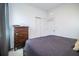Bedroom with a queen bed, dark wood dresser, and gray bedding at 731 Griffon Ave, Lake Alfred, FL 33850