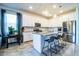 Modern kitchen with white cabinets, granite island, and stainless steel appliances at 731 Griffon Ave, Lake Alfred, FL 33850