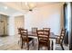 Simple dining room with wooden table and chairs, and a chandelier at 731 Griffon Ave, Lake Alfred, FL 33850