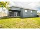 Fenced backyard with covered patio at 731 Griffon Ave, Lake Alfred, FL 33850