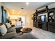 Open concept living room with sectional sofa and a view into the kitchen at 731 Griffon Ave, Lake Alfred, FL 33850