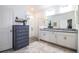 Elegant bathroom with a double vanity, walk-in shower, and grey dresser at 731 Griffon Ave, Lake Alfred, FL 33850