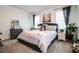 Cozy bedroom with a grey upholstered bed, side tables, and large windows at 731 Griffon Ave, Lake Alfred, FL 33850