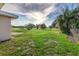 Large backyard with grassy area and distant trees at 5144 Washington St, Lake Wales, FL 33859
