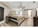 Spacious bedroom with large bed, ceiling fan, and ensuite bathroom at 5144 Washington St, Lake Wales, FL 33859