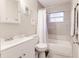 Updated bathroom with white vanity, tile shower/tub combo, and window at 5144 Washington St, Lake Wales, FL 33859