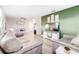 Open living room with two brown sofas and green accent wall at 5144 Washington St, Lake Wales, FL 33859