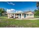 House exterior featuring covered patio and spacious yard at 5144 Washington St, Lake Wales, FL 33859