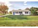 Single story home with a blue door and manicured lawn at 5144 Washington St, Lake Wales, FL 33859