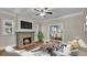 Living room with fireplace, hardwood floors, and view into the kitchen at 1127 N Stella Ave, Lakeland, FL 33805