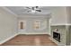 Living room with hardwood floors, fireplace, and ceiling fan at 1127 N Stella Ave, Lakeland, FL 33805