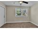 Simple bedroom with ceiling fan, carpet, and one window at 1127 N Stella Ave, Lakeland, FL 33805