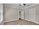 Spacious bedroom with ceiling fan, carpet, and ample closet space at 1127 N Stella Ave, Lakeland, FL 33805
