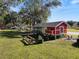 Red chicken coop in a backyard setting at 1805 Providence Rd, Lakeland, FL 33805