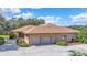 House exterior showcasing a two-car garage and landscaping at 3933 Mammoth Grove Rd, Lake Wales, FL 33898