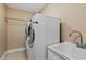 Bright laundry room, washer, dryer, and utility sink at 3933 Mammoth Grove Rd, Lake Wales, FL 33898