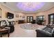 Spacious living room with a large TV, comfortable seating, and a decorative rug at 3933 Mammoth Grove Rd, Lake Wales, FL 33898