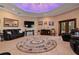 Living room featuring leather furniture and a unique coffered ceiling with LED lighting at 3933 Mammoth Grove Rd, Lake Wales, FL 33898