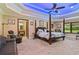 Main bedroom with a post bed, ceiling fan, and blue lighting at 3933 Mammoth Grove Rd, Lake Wales, FL 33898