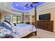 Main bedroom with a post bed, TV, and ample closet space at 3933 Mammoth Grove Rd, Lake Wales, FL 33898