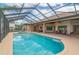 Large pool and spa with covered patio at 3933 Mammoth Grove Rd, Lake Wales, FL 33898