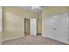 Well-lit bedroom with carpet flooring and double doors at 714 Whisper Woods Dr, Lakeland, FL 33813