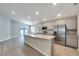 Modern kitchen with stainless steel appliances and an island at 964 Aruba Ave, Mulberry, FL 33860