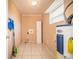 Laundry room with Whirlpool water heater and storage cabinet at 3933 Strickland Ct, Lakeland, FL 33812
