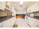 Kitchen with white cabinets, tile floors, and built-in microwave at 3933 Strickland Ct, Lakeland, FL 33812