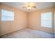 Bright bedroom featuring ceiling fan and two windows with blinds at 3933 Strickland Ct, Lakeland, FL 33812