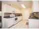 Kitchen with white cabinets, tile floors, and built-in microwave at 3933 Strickland Ct, Lakeland, FL 33812