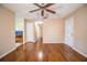 Living room with hardwood floors, ceiling fan and access to kitchen at 3933 Strickland Ct, Lakeland, FL 33812