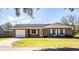 House exterior with a white garage door and front yard at 3933 Strickland Ct, Lakeland, FL 33812