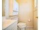 Simple bathroom with white vanity, medicine cabinet, and toilet at 3933 Strickland Ct, Lakeland, FL 33812
